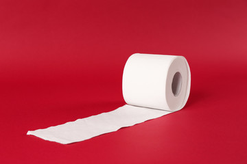 Roll of toilet paper on color background