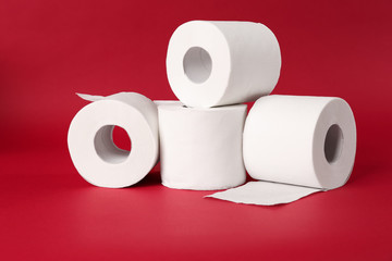 Rolls of toilet paper on color background