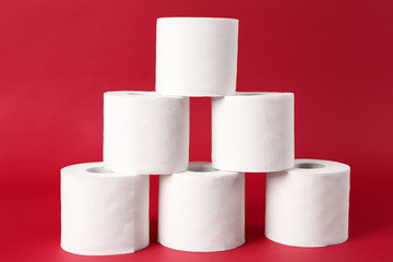 Rolls of toilet paper on color background