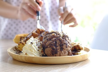 Ice cream,cream and waffles in a wooden dish served as a snack for children at break time.