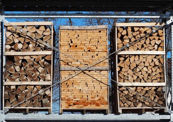 Different types of chopped firewood in packing on three pallets