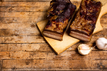Homemade smoked pork bacon on a cutting board