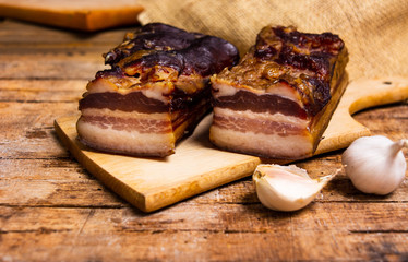 Homemade smoked pork bacon on a cutting board