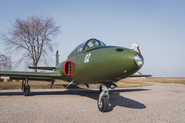 Big old green jet plane parked on the runway