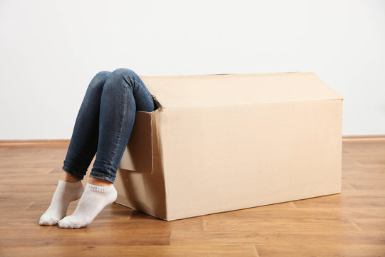 Cardboard box with female legs