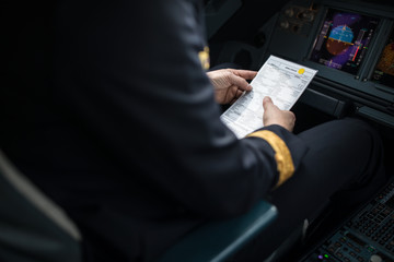 Pilot's hand accelerating on the throttle in  a commercial airliner airplane flight cockpit during...
