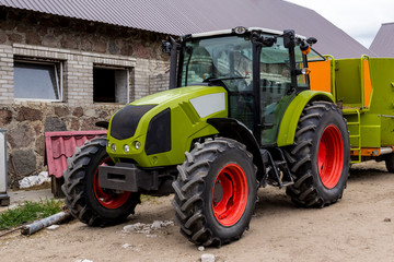 General view of a powerful tractor for various agricultural works. Necessary equipment for a dairy farm.