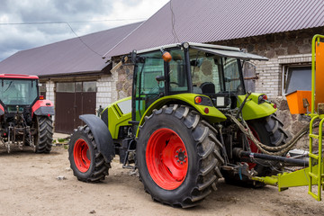 General view of a powerful tractor for various agricultural works. Necessary equipment for a dairy farm.