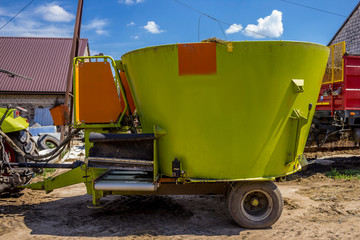 Trailer for mixing and distribution of feed for cows. Necessary equipment for a dairy farm.