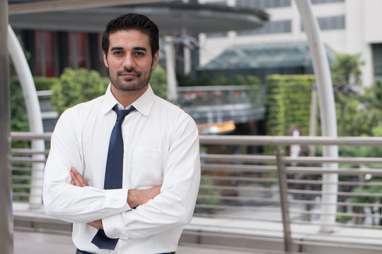 asian business man crossing arm; portrait of Asian, north indian successful and confident businessman