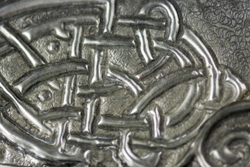 texture with embossed drawing on tin foil