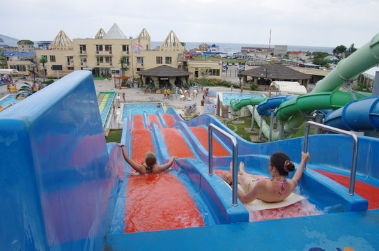 Colorful slides in tropical outdoor water park.