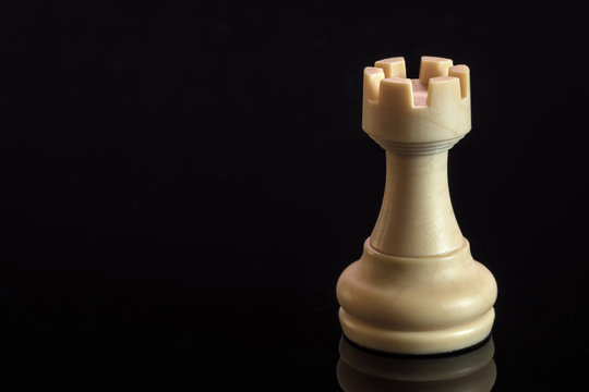 Classic Chess White Rook on black surface, isolated