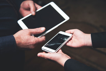 girl hand phone and man hand tablet