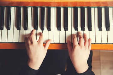 girl hand playing piano