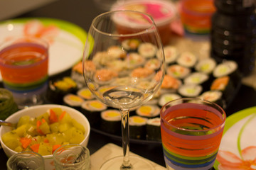 Fototapeta na wymiar sushi colorful mix served dinner with wine, glasses, on table at restaurant, evening date, food photography