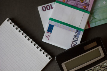 bundle of money calculator on a black background