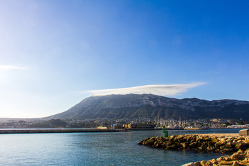 Panoramic view of Denia port and promenade, with Montgó mountain in the background