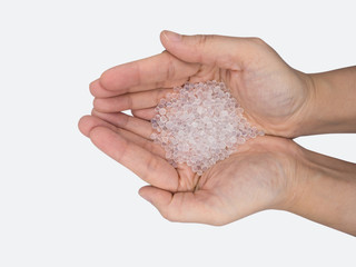 Close up of hand holding silica gel on white background, Desiccant attract moisture for chemical.