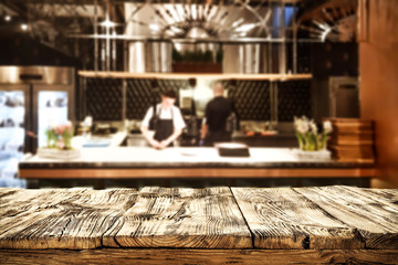 Table background of free space and kitchen interior of restaurant. 