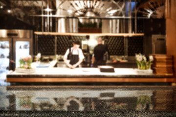 Table background of free space and kitchen interior of restaurant. 