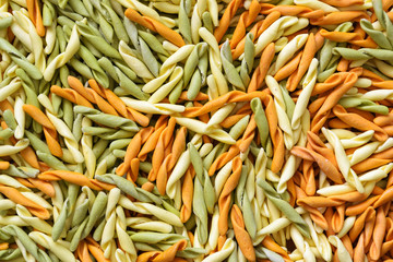 Background from multi-colored pasta. Traditional Italian cuisine.