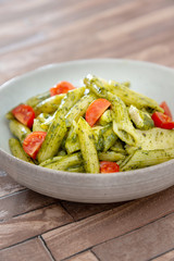 Pasta with pesto sauce and nuts on a the table