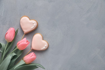 Springtime background with pink tulips on grey concrete , text space