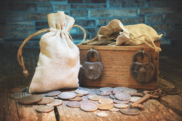Pouch with old money and coins.Treasure chest.Padlocks and keys.Travel and marine engraving background.Vintage style.Treasure searching concept.Gold,silver.Numismatics 