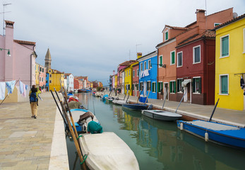 Fototapeta na wymiar Painted houses near a canal in Burano, Italy