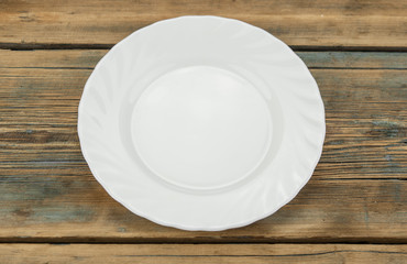 Blank white dish on a wood background