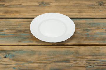 Blank white dish on a wood background