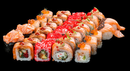 Set of sushi rolls on black background