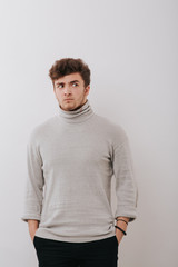 portrait of a young man scared and frightened, isolated background gray, copy space