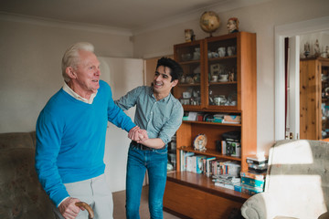 Obraz premium Teenager Helping his Grandfather at Home