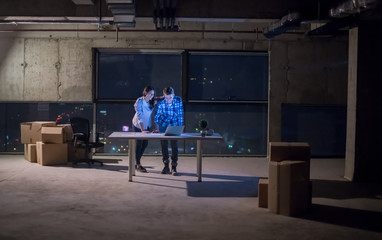business people on construction site  in new startup office at night