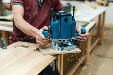 Manual wood concept. Cropped photo of cabinetmaker handyman stand half turn to camera hold electric...