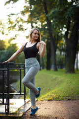 Beautiful blond girl posing for photo at sunrise