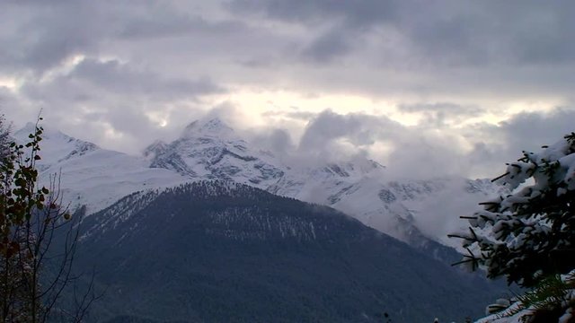 Winter landscape with mountains and clouds - time lapse