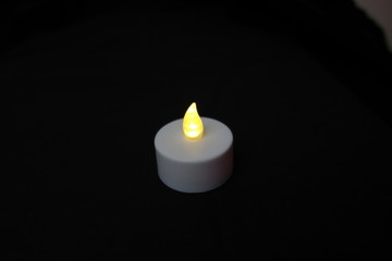 electric candle burning faded isolated on white background