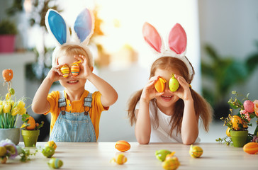 Happy easter! funny funny children   with ears hare getting ready for  holiday.