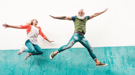 Senior crazy couple jumping outdoor