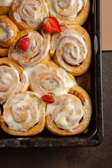Fresh cinnamon rolls on baking sheet