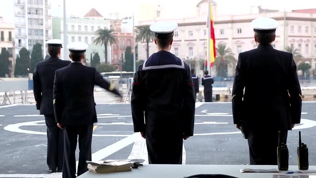Performing the daily Flag Lowering Ceremony in spanish military ship