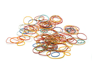 Rubber bands randomly scattered on a white surface