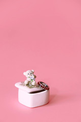 silver ring with precious red stones on the background of a decorative white ceramic casket with a gift