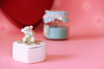 silver ring with precious red stones on the background of a decorative white ceramic casket with a gift