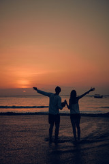 Silhouette of a girl in sunset / sunrise time over the ocean.