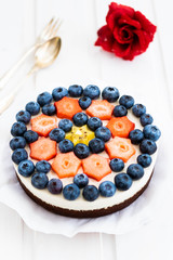 vegan cheese cake with chocolate flan case and vegan cream cheese, ground almonds, vanilla pulp and fresh fruits