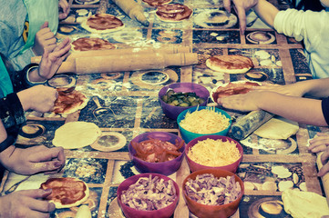 Table in flour and pizza ingredients. Children's master class young chefs.